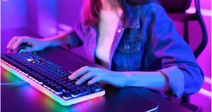 Woman Using Gaming Keyboard At Desk